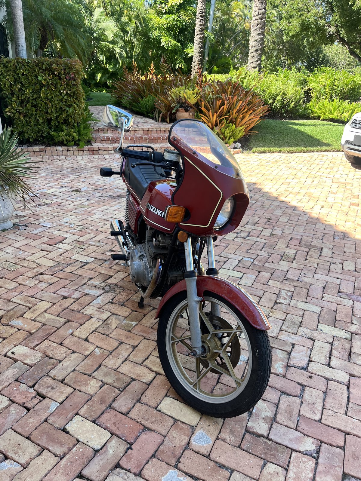 Suzuki GS450S front three-quarter with landscaping